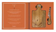Load image into Gallery viewer, Wooden cutting board and cheese knife set on an orange background with text on the left.