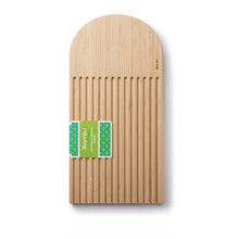Load image into Gallery viewer, A beige bamboo arch bread board with grooves for catching crumbs, featuring a label with the brand 'Bambu'.