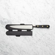 Load image into Gallery viewer, Knife with a black sheath on a light gray marble surface