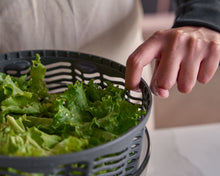 Load image into Gallery viewer, Person holding a basket of green leafy vegetables