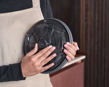 Load image into Gallery viewer, Person holding a salad spinner lid