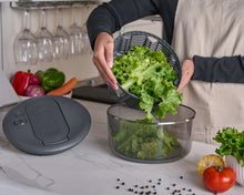 Load image into Gallery viewer, Person transferring lettuce from a salad spinner into a bowl on a kitchen counter.