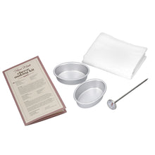 Load image into Gallery viewer, 'Homemade' Cheese Making Kit with recipe card, two cheese moulds, a muslin cloth, and a thermometer on a white background