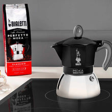 Load image into Gallery viewer, Bialetti Moka Induction coffee maker with a package of Bialetti coffee on a kitchen counter.