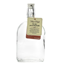 Load image into Gallery viewer, A clear glass flask bottle with a clip top and a label that reads 'Home Made Preventing Bottle'.