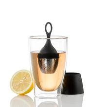 Load image into Gallery viewer, Glass of tea with a black tea infuser and lemon slice on a white background