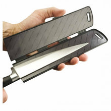 Load image into Gallery viewer, Knife with a black sheath held by a hand on a white background