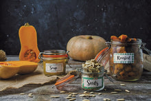 Load image into Gallery viewer, three glass jars with clip top lids and handwritten labels on a rustic wooden table with various pumpkins and squash