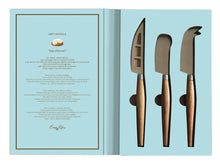 Load image into Gallery viewer, Set of three cheese knives with wooden handles on a light blue background
