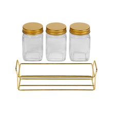 Load image into Gallery viewer, Three glass jars with gold lids and a gold metal shelf on a white background

