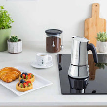 Load image into Gallery viewer, Stainless steel espresso maker on a kitchen counter with pastries and coffee.
