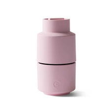 Load image into Gallery viewer, A rose pink, cylindrical Billund CrushGrind mill, featuring a silicone plug at the bottom.
