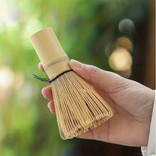 Load image into Gallery viewer, hand holding bamboo matcha tea whisk
