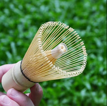 Load image into Gallery viewer, hand holding bamboo matcha tea whisk
