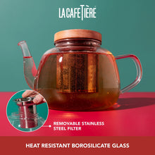 Load image into Gallery viewer, Glass teapot with wooden lid on a red and green background, featuring La Cafétière branding.
