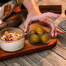 Load image into Gallery viewer, Person holding a bowl of pickles on a wooden board with a &#39;RESERVED&#39; sign in the background.

